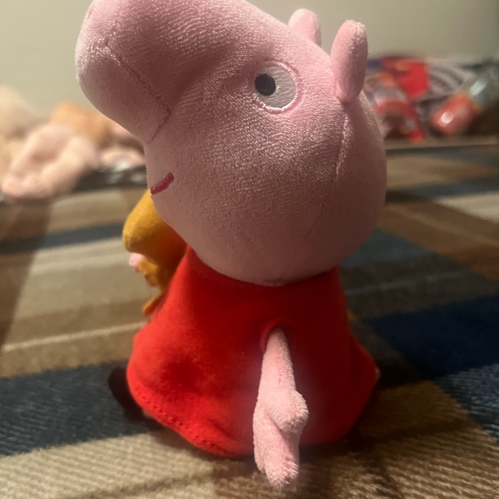 Peppa pig hugging teddy bear